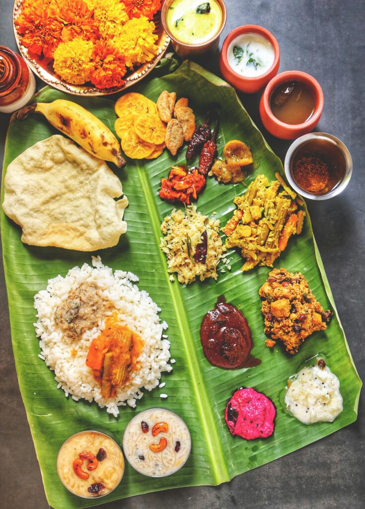 pexels photo 5410418 5410418 A vibrant display of Kerala Sadya on banana leaf, featuring traditional Onam dishes.